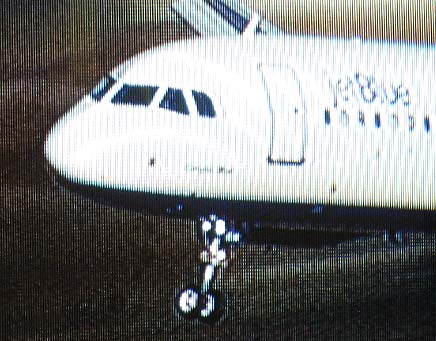 jetBlue airplane with damaged nose gear